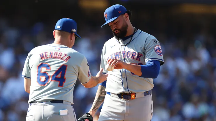Sean Manaea #59 of the New York Mets reacts hands the ball to Carlos Mendoza #64.