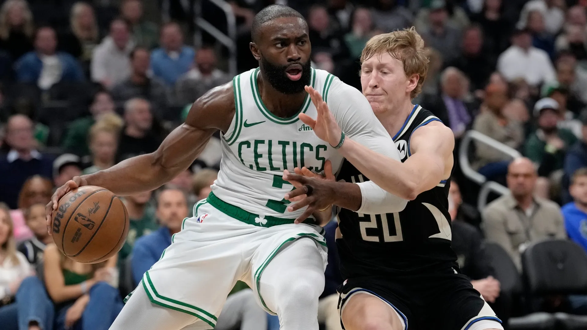 Jaylen Brown #7 of the Boston Celtics dribbles the ball against A.J. Green in 2026 (Source: Patrick McDermott/Getty Images)