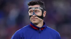 Robert Lewandowski of FC Barcelona looks on whilst wearing a protective face shield.