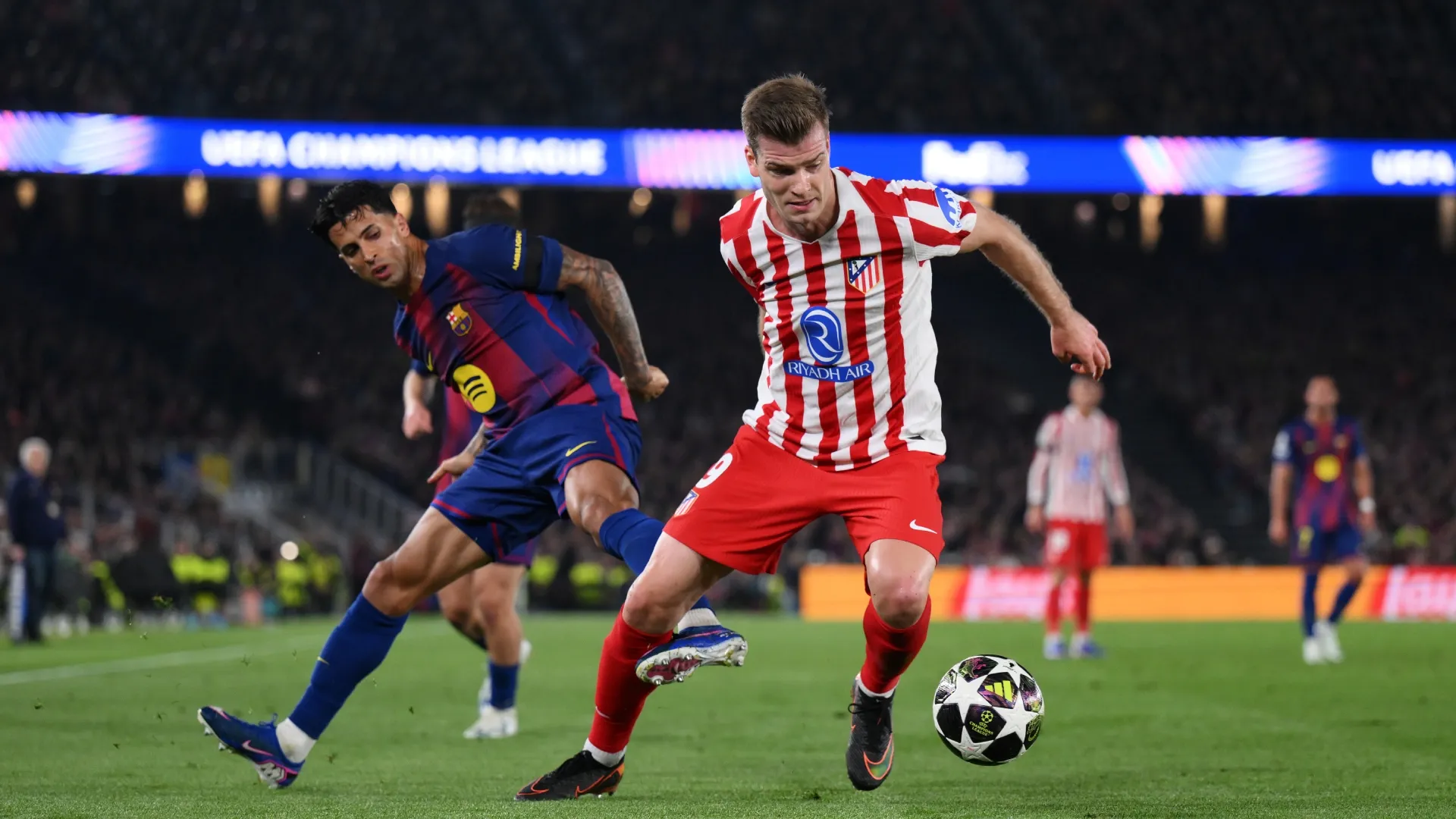 Alexander Sorloth of Atletico Madrid is challenged by Joao Cancelo of Barcelona – David Ramos/Getty Images