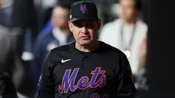 Manager Carlos Mendoza of the New York Mets walks through the dugout.