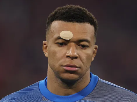 Why is Mbappe playing with a plaster in his face?