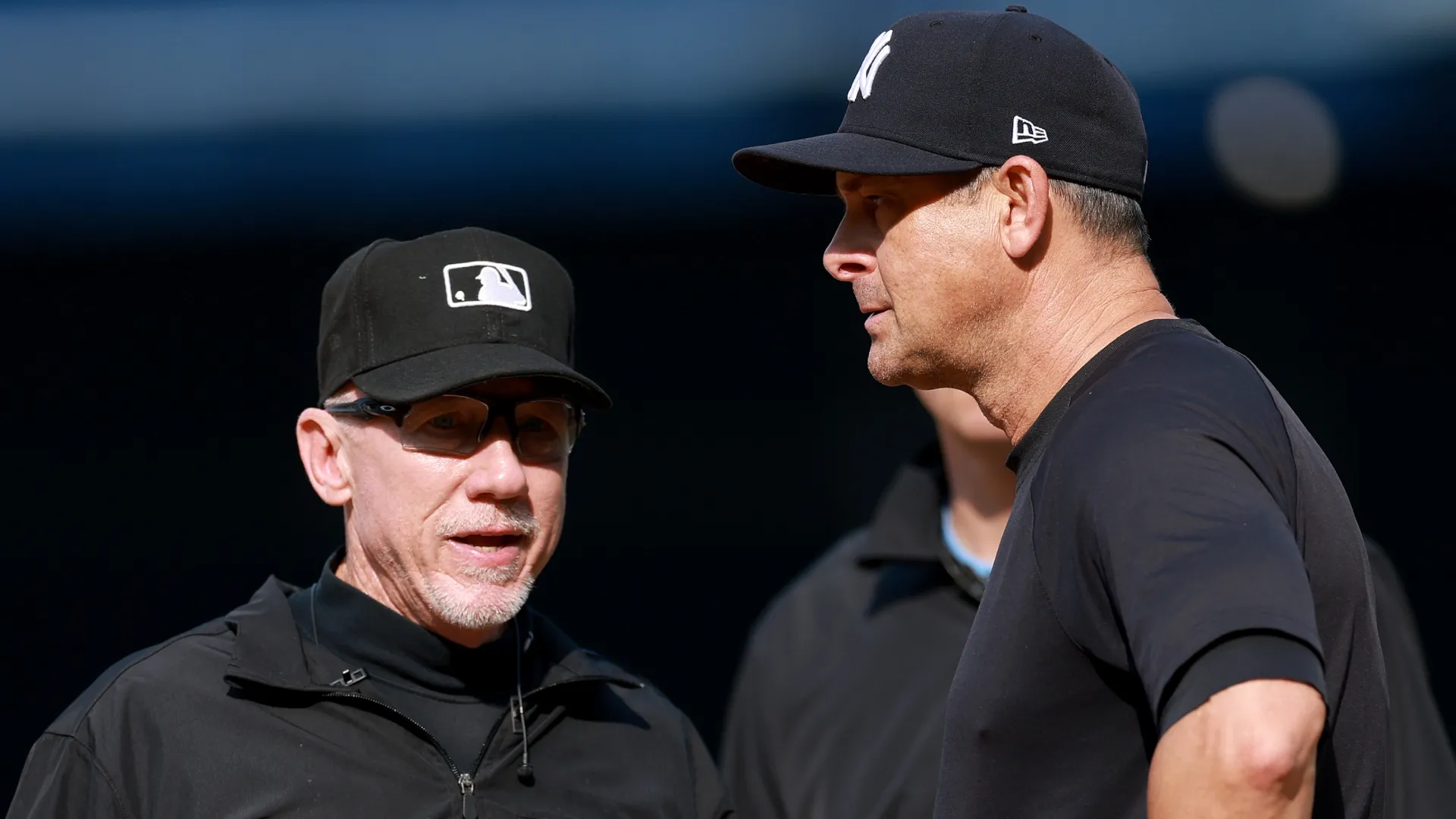Manager Aaron Boone #17 of the Yankees discusses a call with umpire Lance Barksdale #23. Elsa/Getty Images