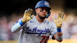 Miguel Rojas #72 of the Dodgers celebrates towards the dugout.