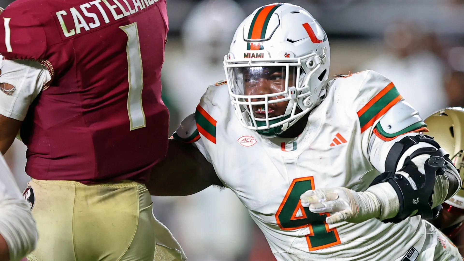 Rueben Bain Jr. pressures Tommy Castellanos #1 of the Florida State Seminoles in 2025 (Source: Jason Clark/Getty Images)
