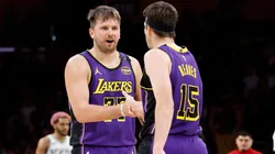 Luka Doncic #77 slaps hands with Austin Reaves #15 of the Los Angeles Lakers.
