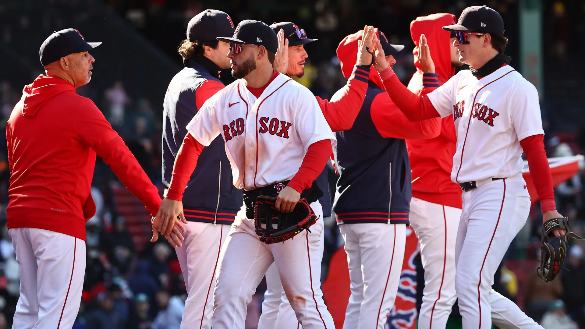Roman Anthony #19 of the Boston Red Sox, lright, and Wilyer Abreu #52 are congratulated by teammates and manager Alex Cora #13. Winslow Townson/Getty Images