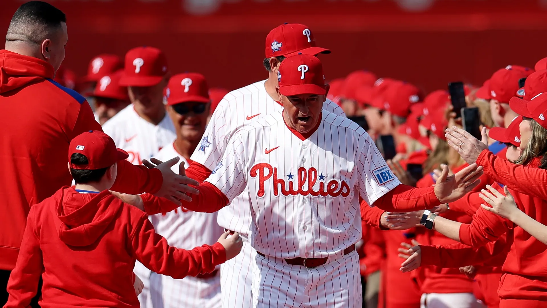 Phillies manager Rob Thomson high fives fans on Opening Day.  Emilee Chinn/Getty Images