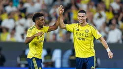 Kingsley Coman of Team Al-Nassr FC celebrates scoring a goal with teammate Cristiano Ronaldo.