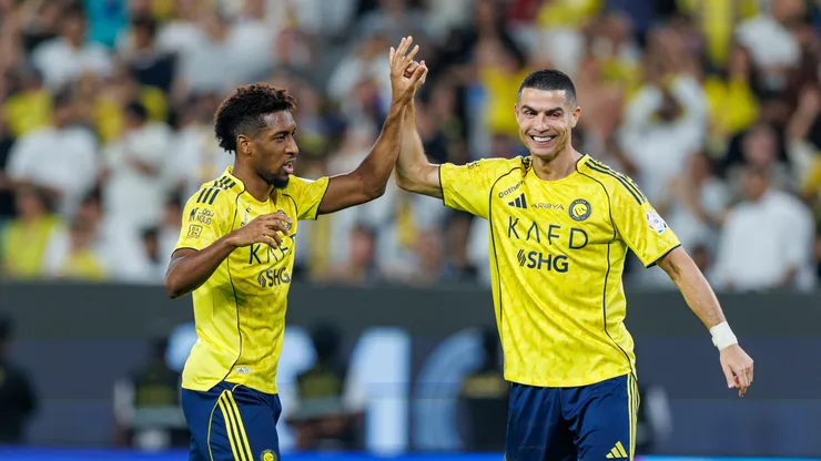 Kingsley Coman of Team Al-Nassr FC celebrates scoring a goal with teammate Cristiano Ronaldo.