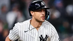 Giancarlo Stanton #27 of the Yankees runs to first after hitting an RBI double.