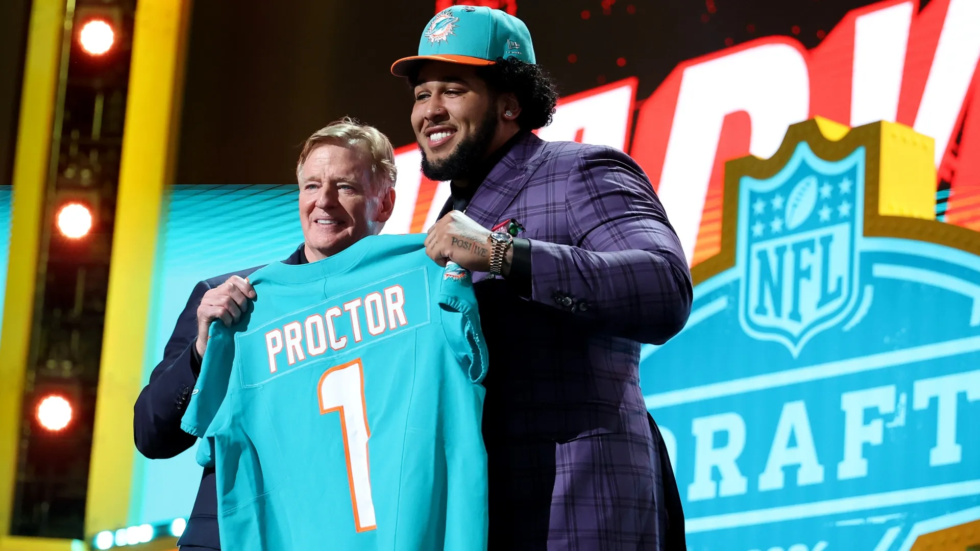 Kadyn Proctor (R) of Alabama poses with NFL Commissioner Roger Goodell (L)