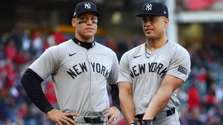 Aaron Judge #99 and Giancarlo Stanton #27 of the New York Yankees look on.