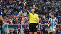 Referee Daniele Orsato shows a yellow card.