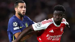 Bukayo Saka of Arsenal (right) is challenged by David Hancko of Atletico Madrid.