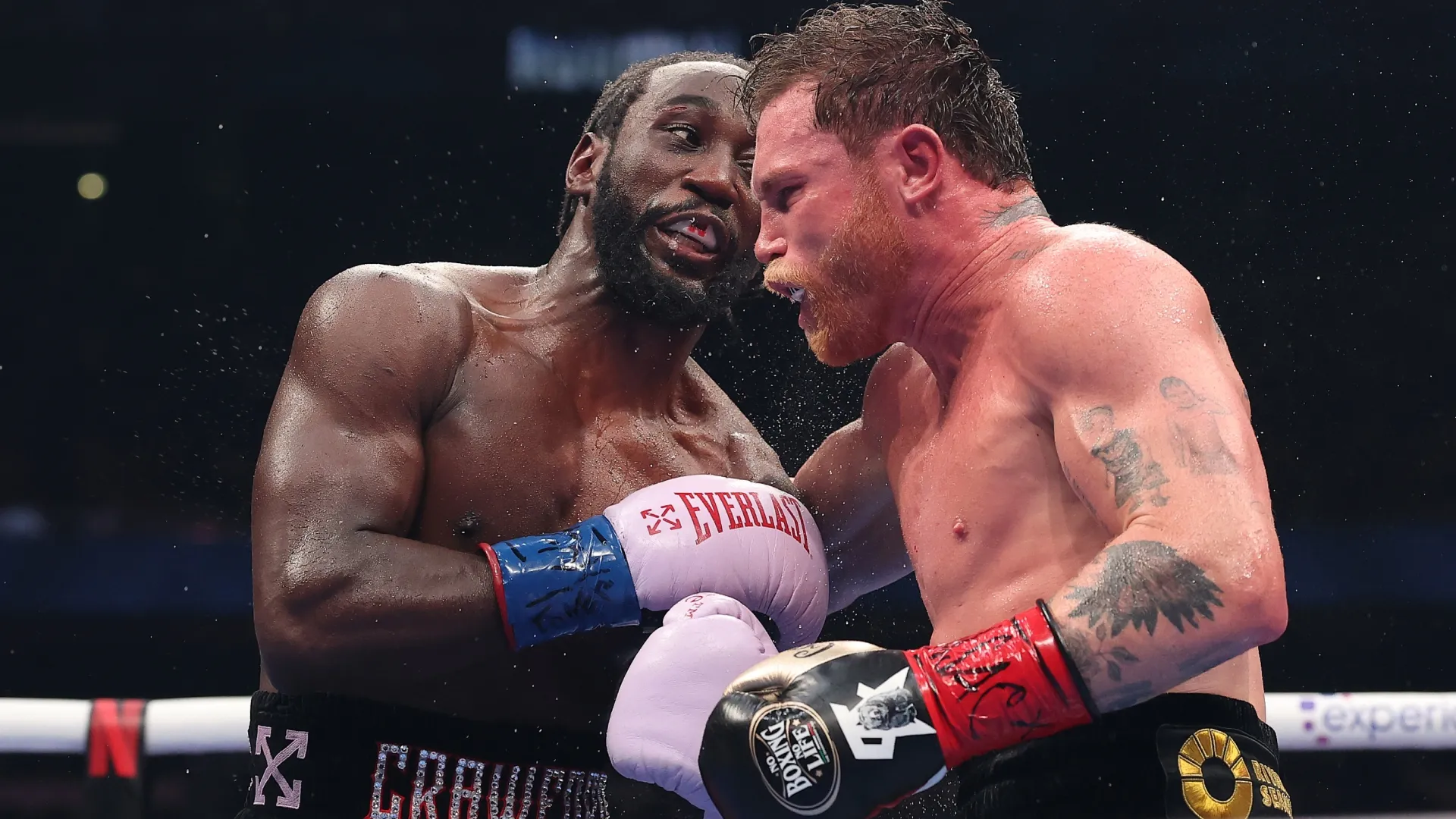 Terence Crawford exchanges punches with Canelo Alvarez. Sarah Stier/Getty Images for Netflix