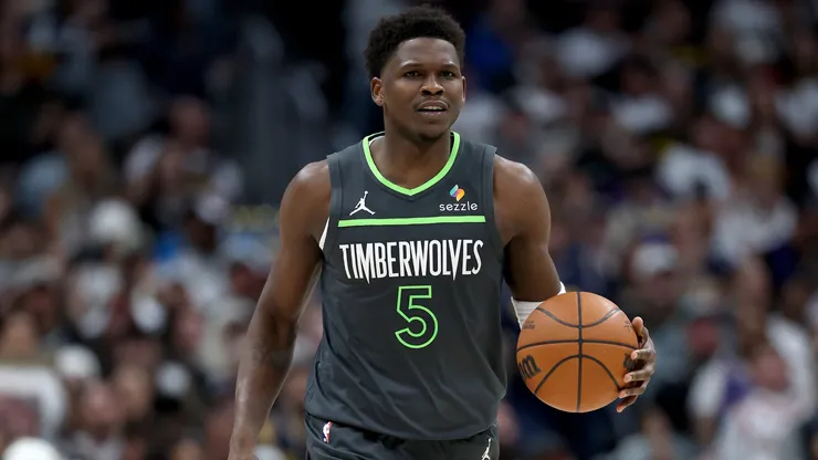 Anthony Edwards #5 of the Minnesota Timberwolves brings the ball down the court against the Denver Nuggets.