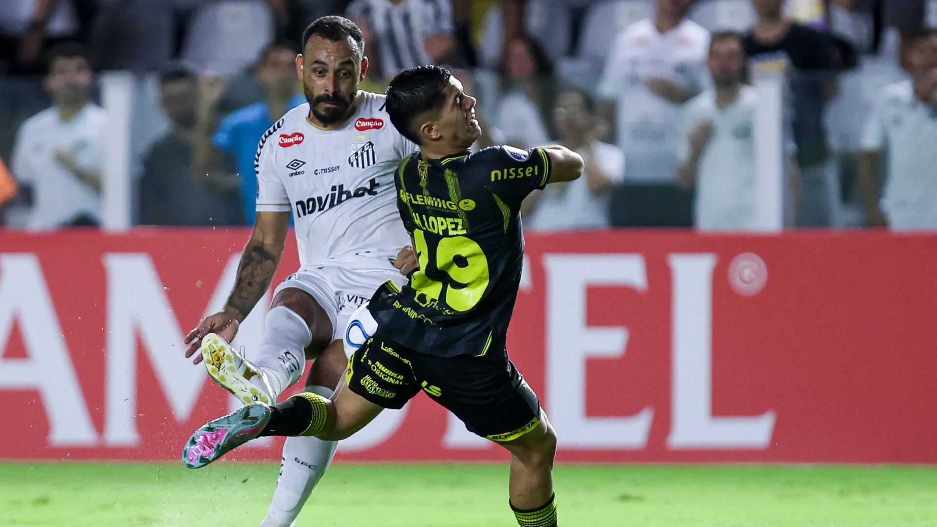 Moises Vieira of Santos fights for the ball with Hector Lopez of Recoleta FC – Ricardo Moreira/Getty Images