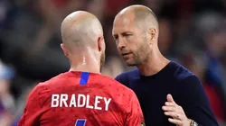 Michael Bradley (left) listens to Gregg Berhalter during a USMNT game.
