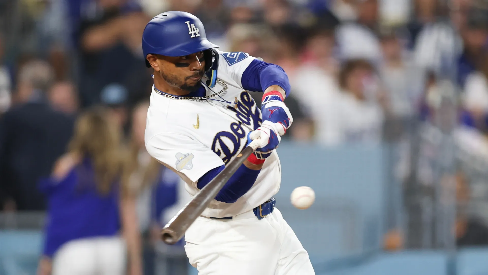 Mookie Betts #50 of the Los Angeles Dodgers hits a three run home run. Luke Hales/Getty Images