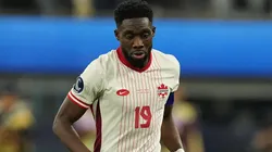 Alphonso Davies #19 of Canada controls the ball.