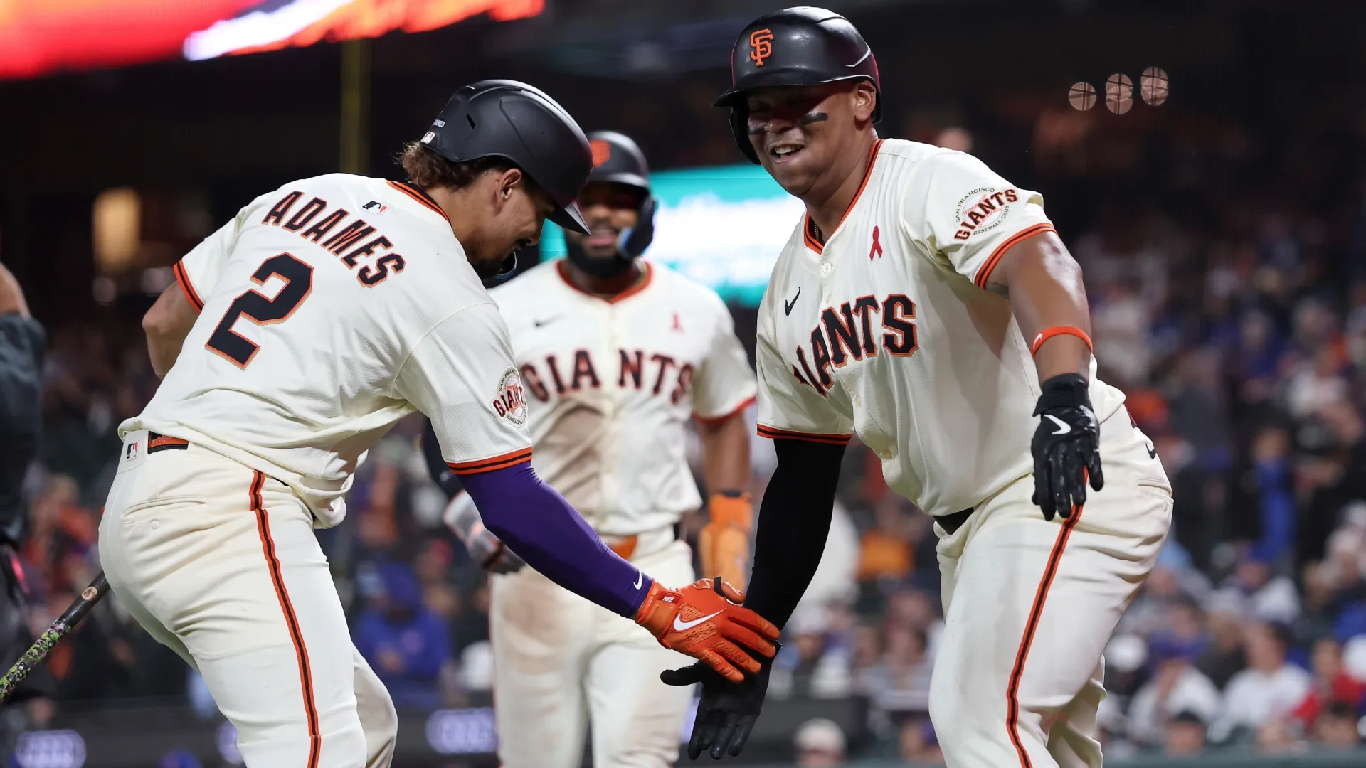 Rafael Devers #16 of the Giants is congratulated by Willy Adames. Ezra Shaw/Getty Images