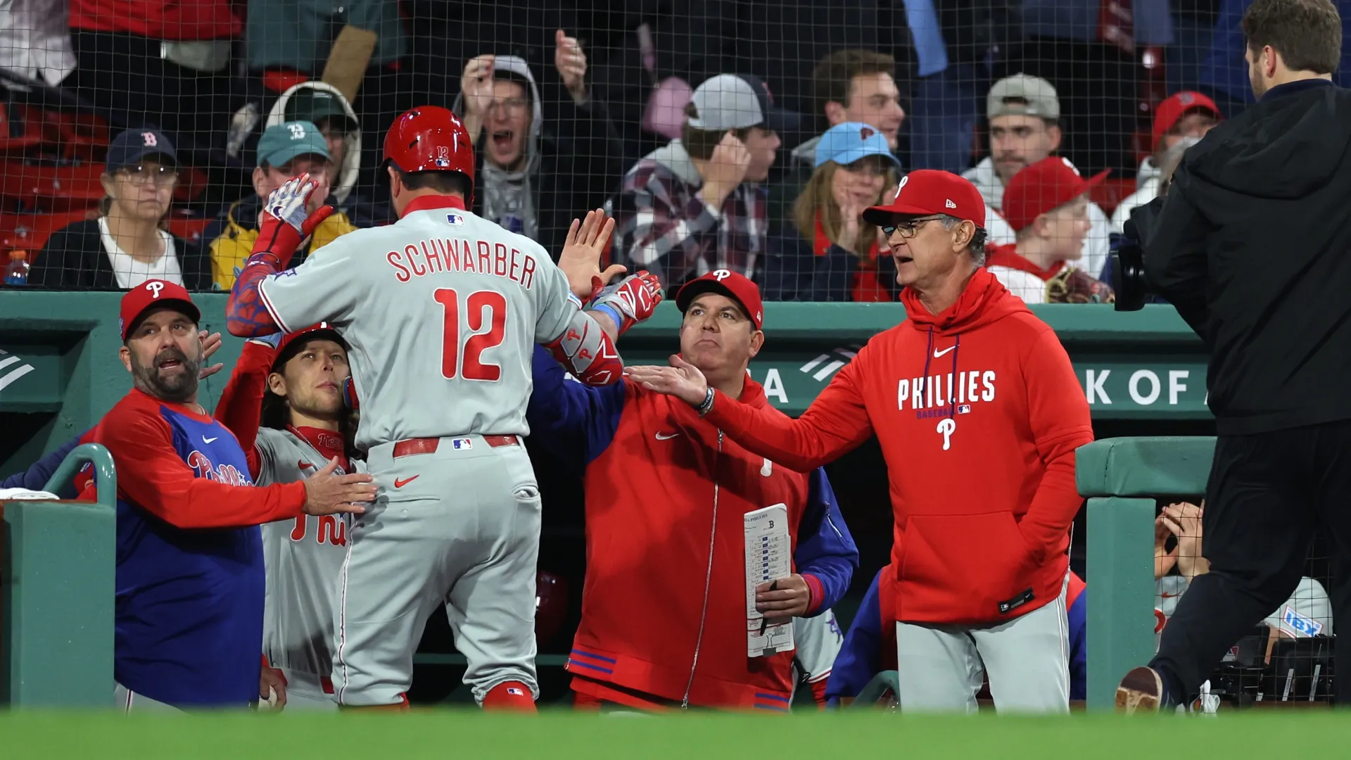 Don Mattingly and Kyle Schwarber of the Phillies celebrate during the eighth inning. Paul Rutherford/Getty Images