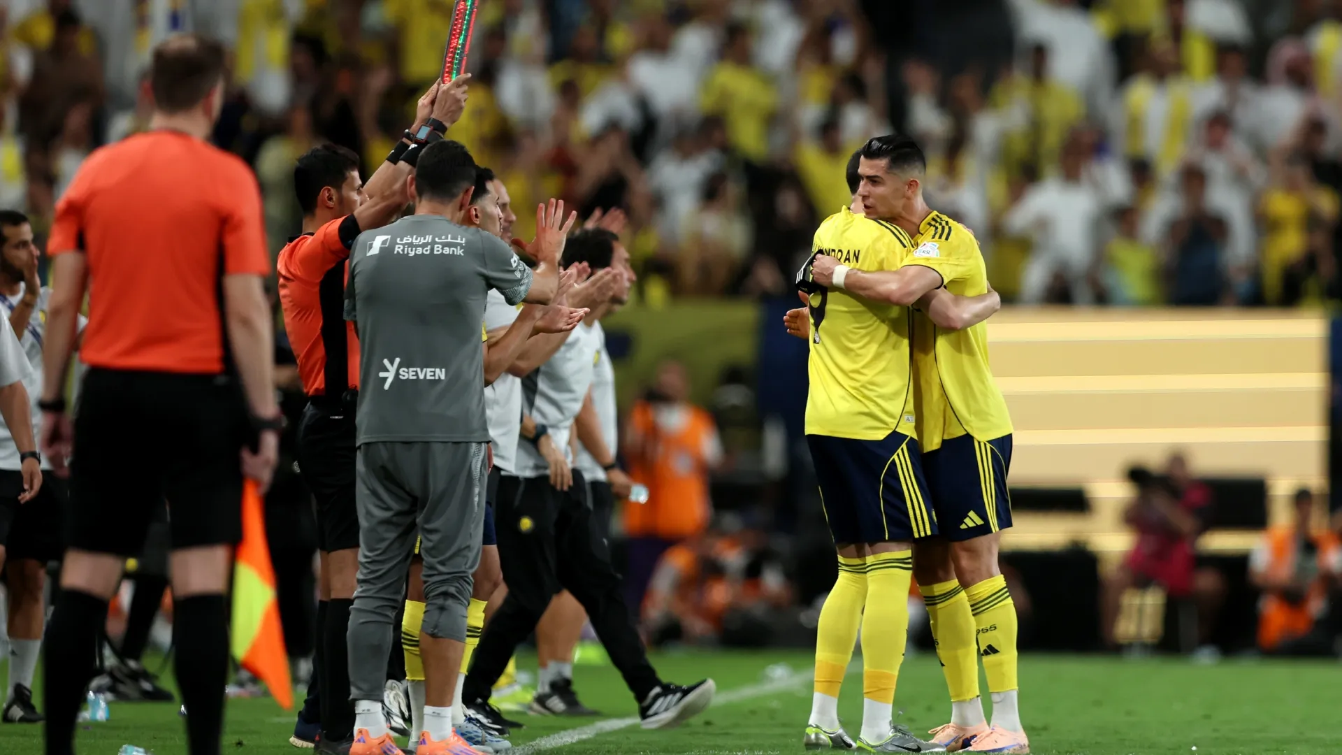 Cristiano Ronaldo of Al Nassr interacts with teammate Abdullah Al Hamdan. Yasser Bakhsh/Getty Images