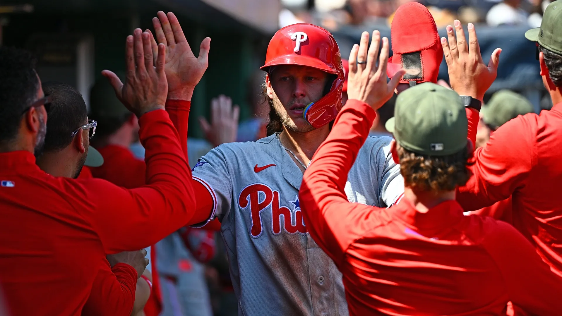 Alec Bohm #28 of the Phillies celebrates with teammates in the dugout. Justin Berl/Getty Images