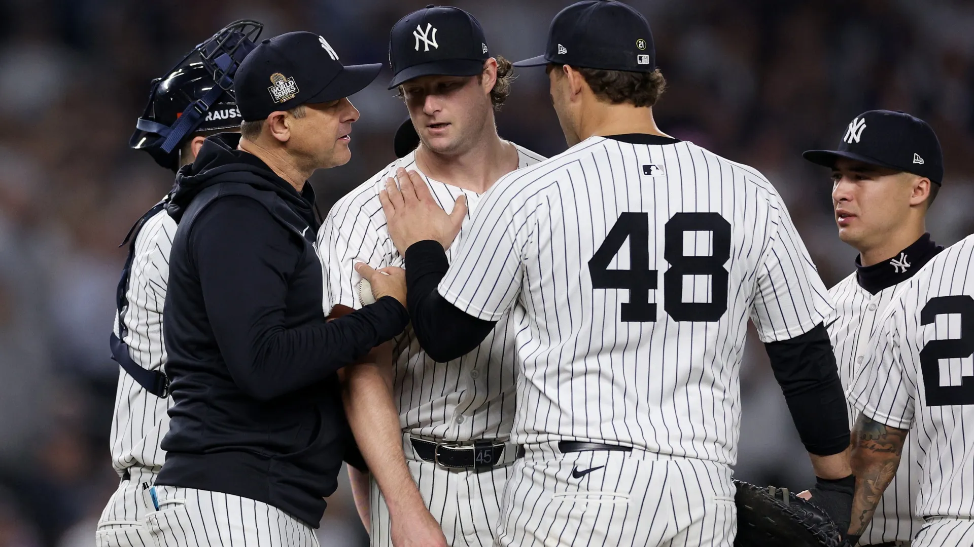Aaron Boone #17 of the Yankees relieves starting pitcher Gerrit Cole #45. Elsa/Getty Images