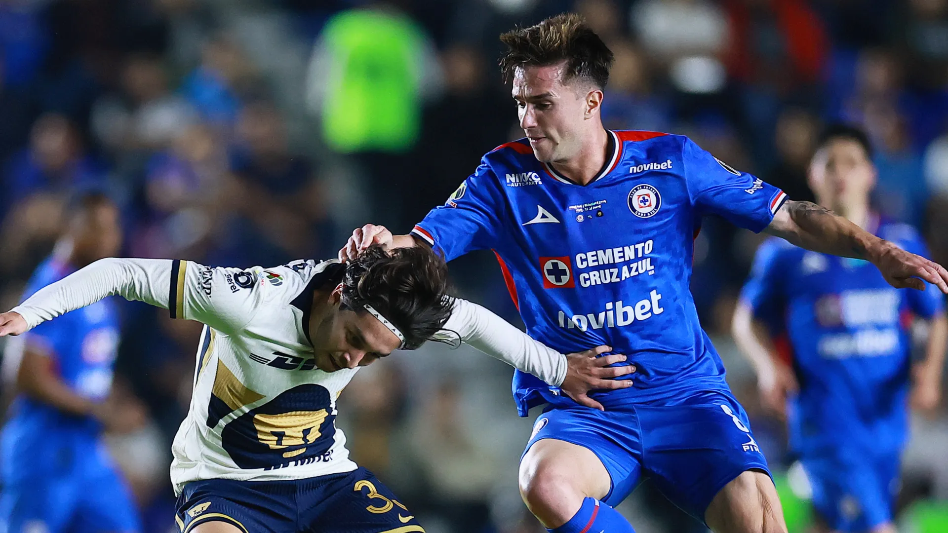Jordan Carrillo of Pumas and Agustin Palavecino of Cruz Azul.