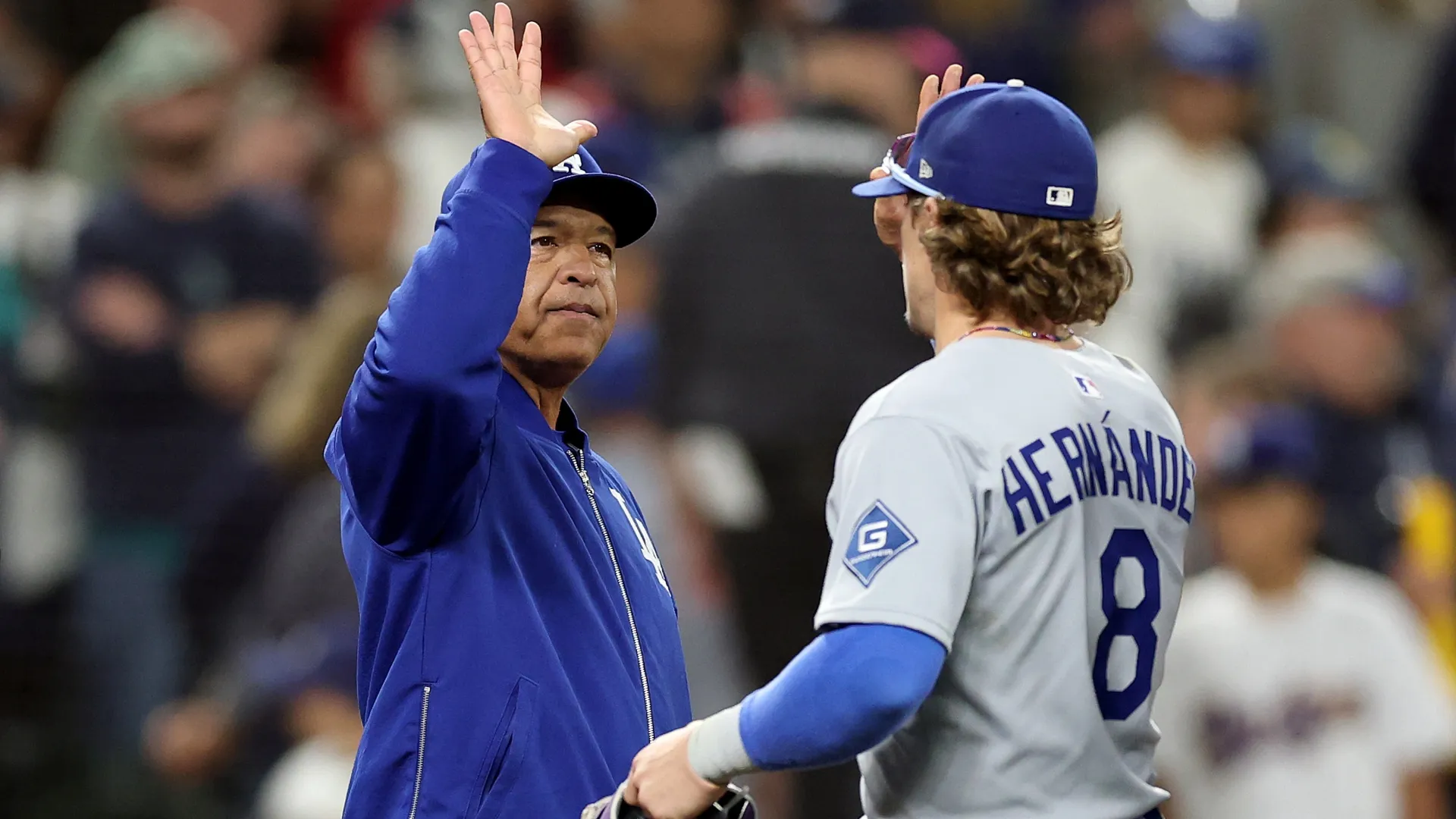 Dave Roberts #30 high fives Enrique Hernandez #8 of the Dodgers. Steph Chambers/Getty Images)