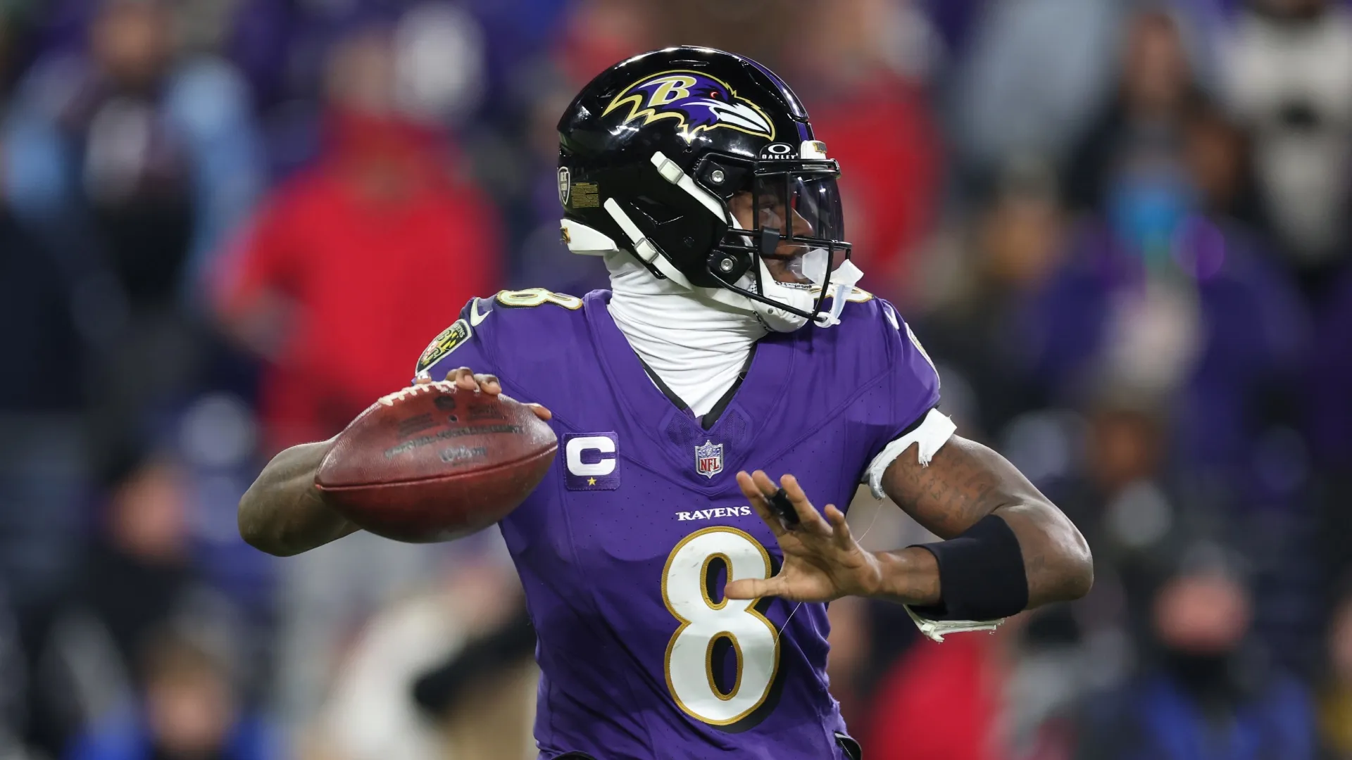 Lamar Jackson throwing a pass during a Ravens game.