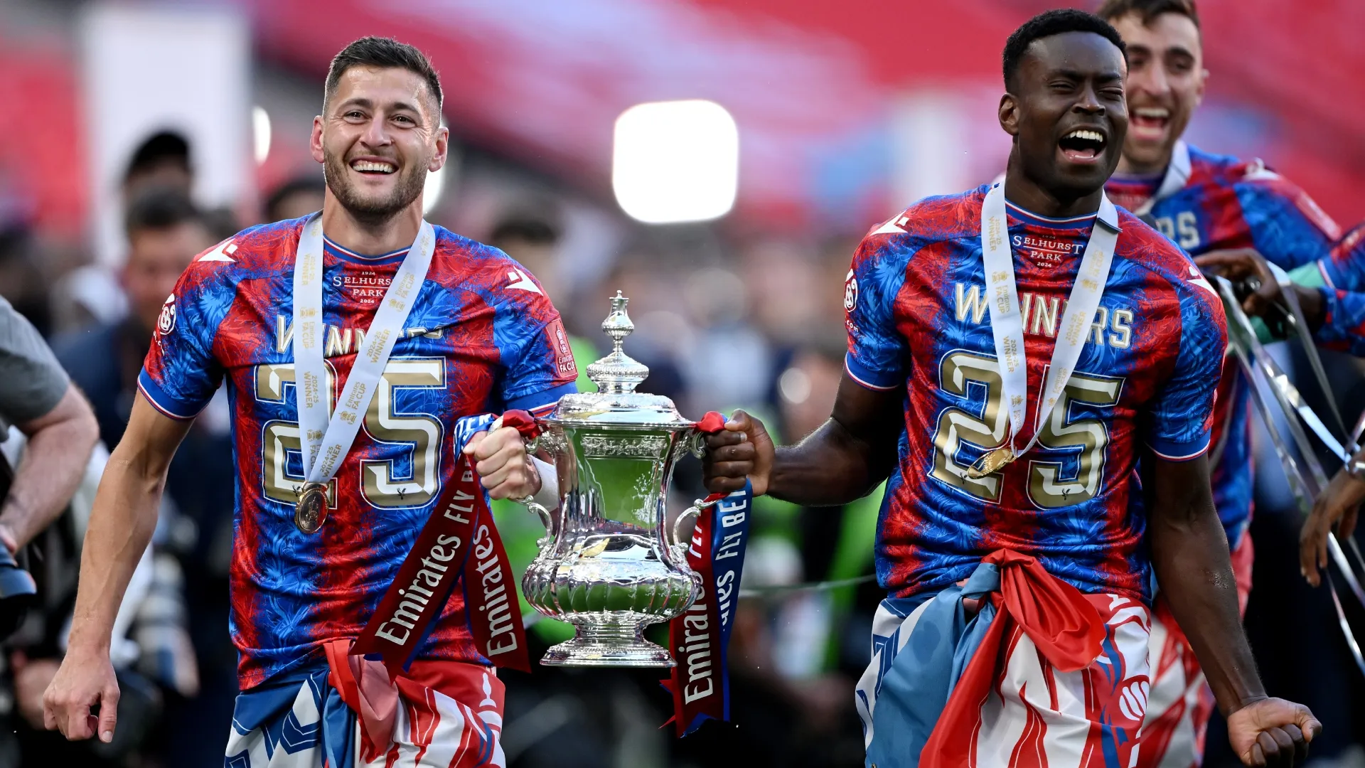 Marc Guehi and Joel Ward of Crystal Palace celebrate with the FA Cup trophy (Source: Mike Hewitt/Getty Images)