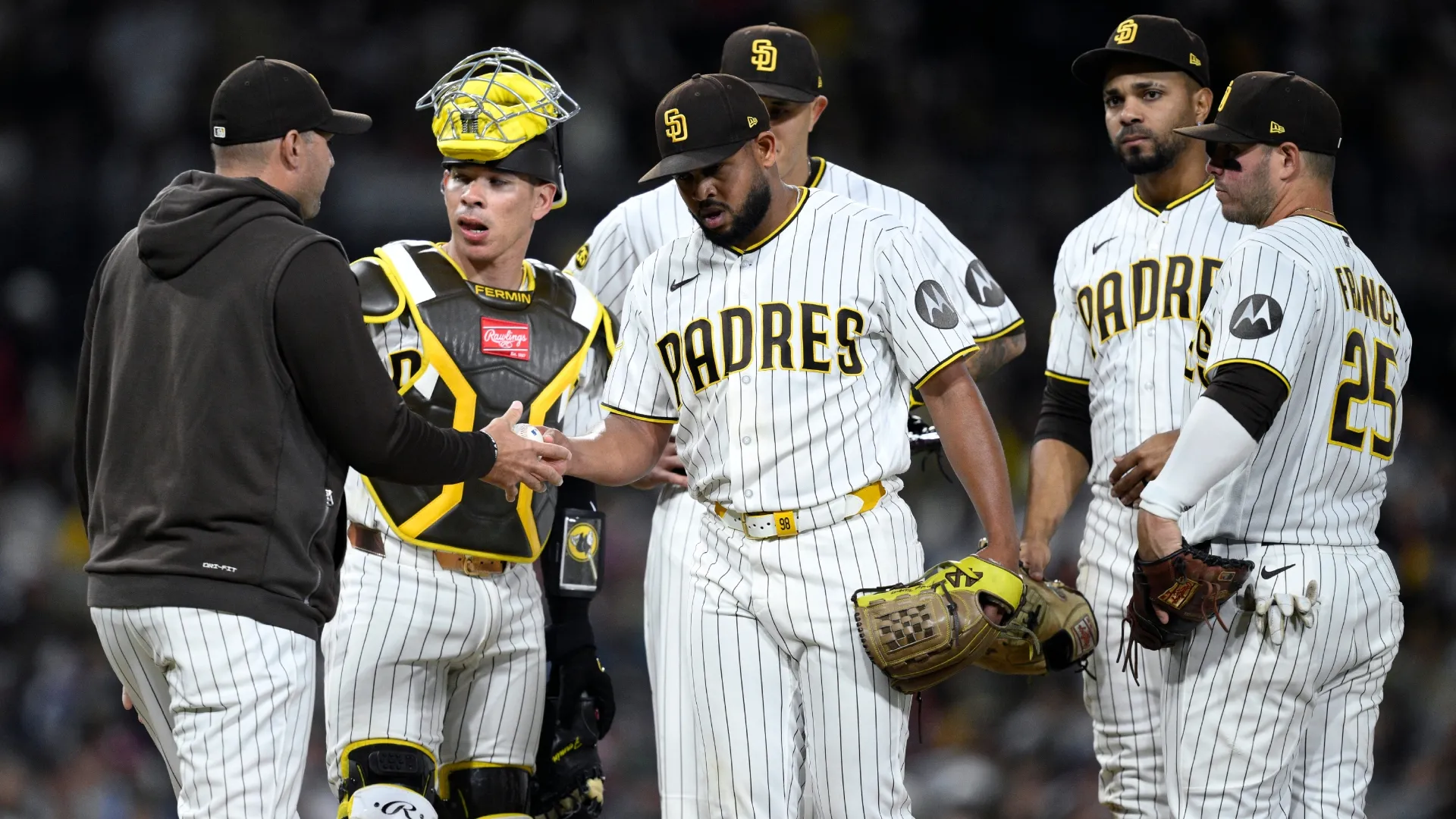 Craig Stammen #14 of the Padres takes the ball from Randy Vasquez. Orlando Ramirez/Getty Images