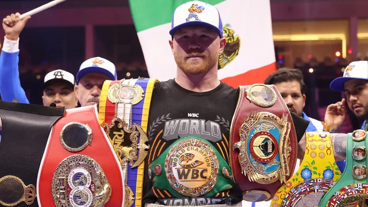 Saul "Canelo" Alvarez poses for a photo with his belts.