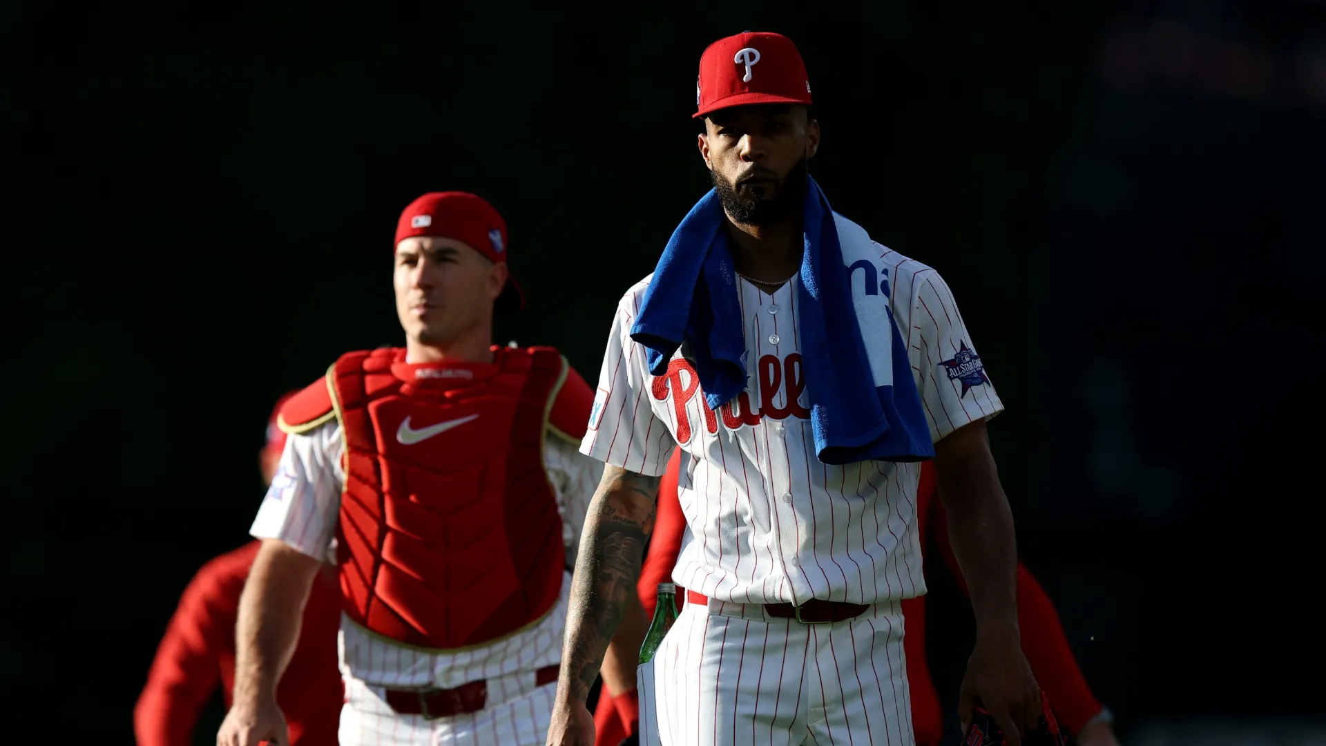Cristopher Sanchez #61 of the Phillies walks from the bullpen with J.T. Realmuto. Emilee Chinn/Getty Images