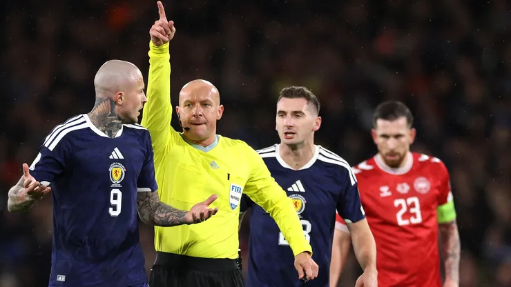 Referee Szymon Marciniak makes a decision during the FIFA World Cup 2026 qualifier match