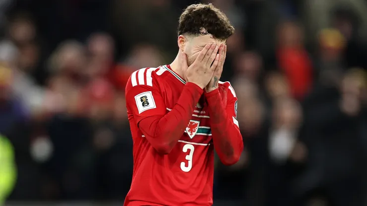 Neco Williams of Wales reacts after missing his penalty.