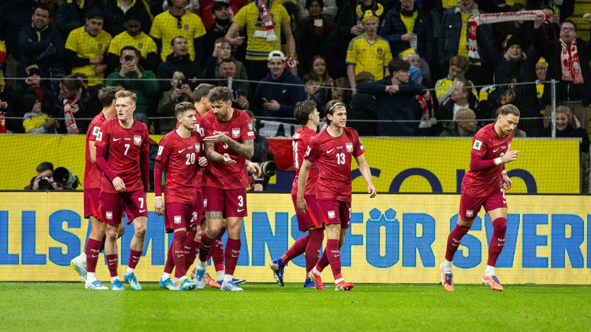 Players from Poland celebrate after scoring 1-1 during the FIFA World Cup 2026 European Qualifiers KO play-offs. Michael Campanella/Getty Images