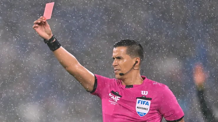 Referee Daniel Quintero shows a red card.
