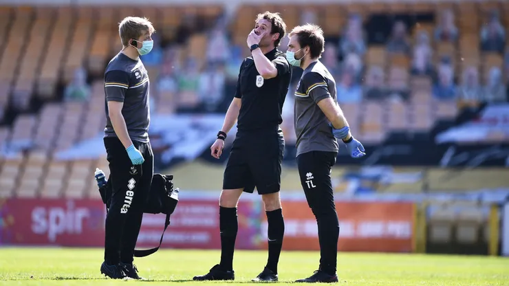 Referee Leigh Doughty reacts after going down injured.