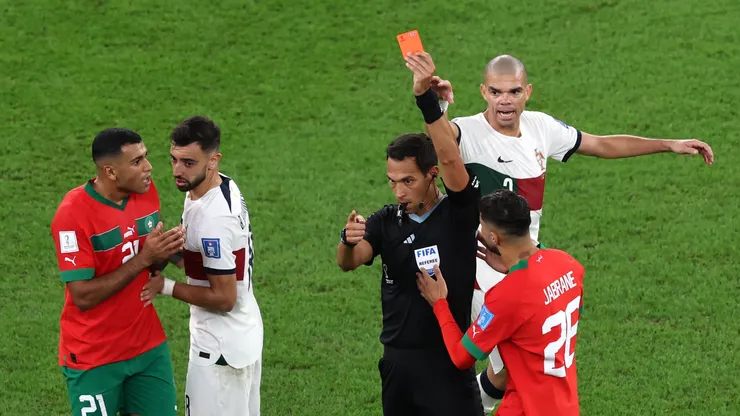 Referee Facundo Tello shows a red card to Walid Cheddira of Morocco after a second yellow during the FIFA World Cup Qatar 2022