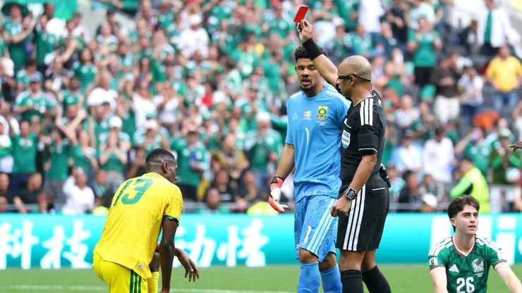 Referee Wilton Sampaio issues a red card to Sphephelo Sithole #13 of South Africa.