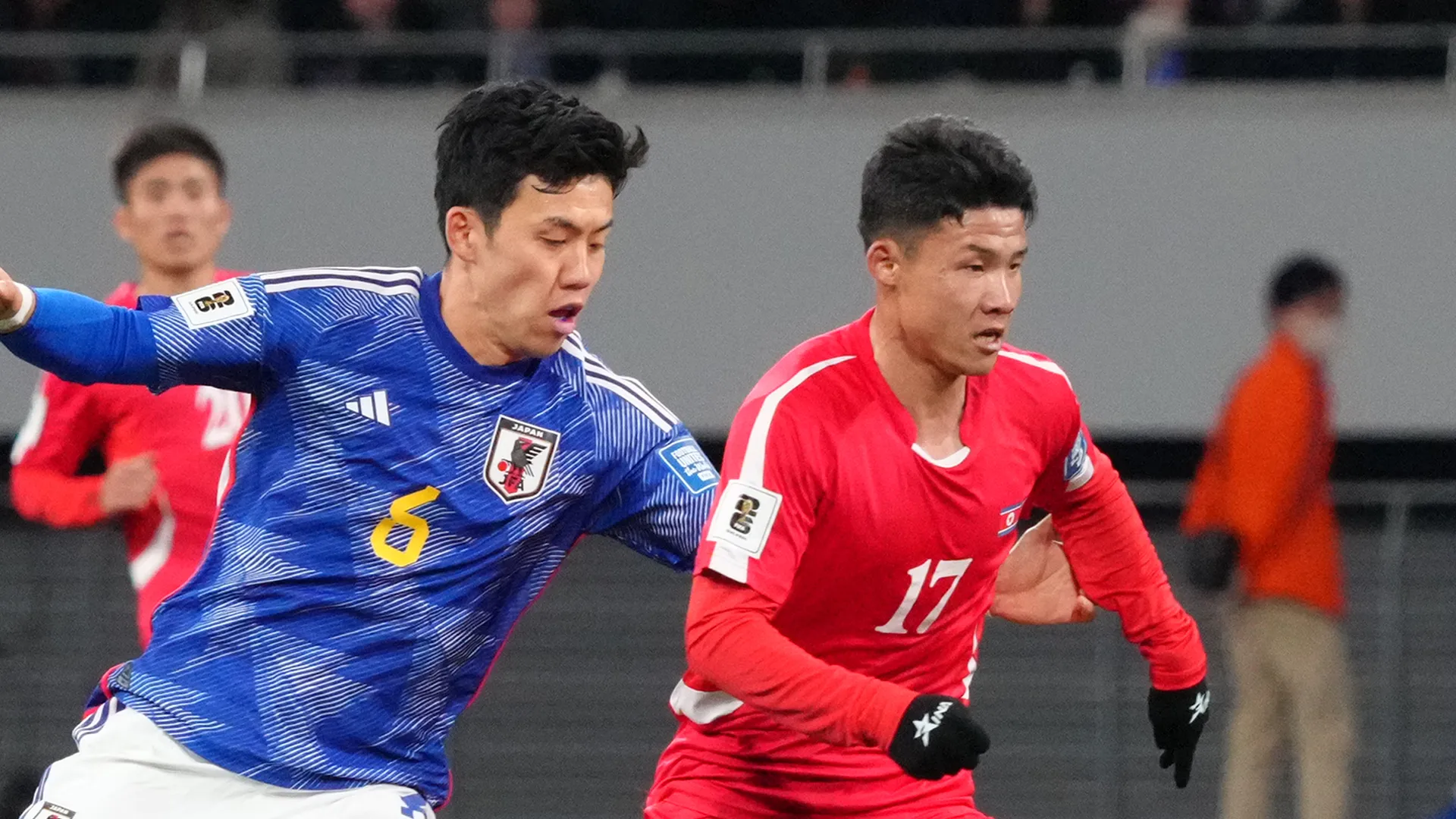 Kang Kuk Chol of North Korea is challenged by Wataru Endo of Japan.