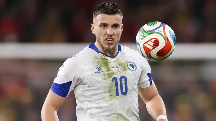 Ermedin Demirovic of Bosnia and Herzegovina controls the ball.
