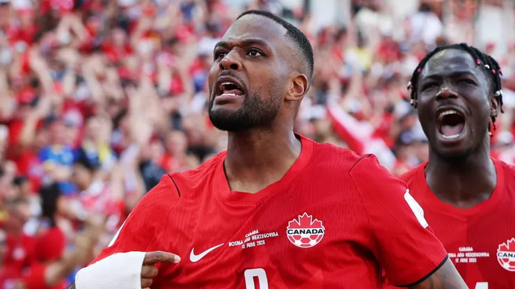 Cyle Larin #9 of Canada celebrates with teammates after scoring the team's first goal.