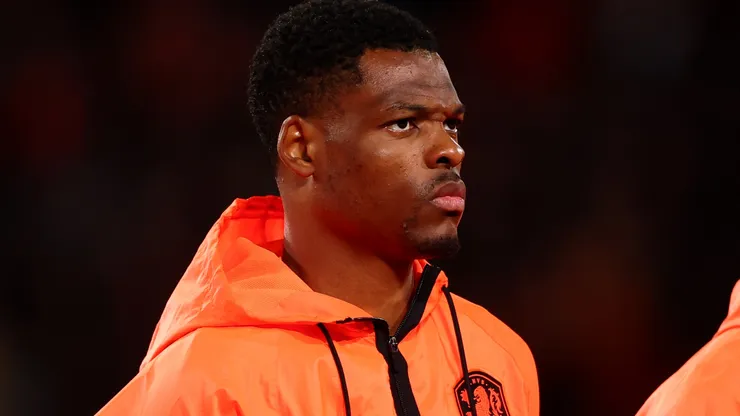 Denzel Dumfries of Netherlands stands.