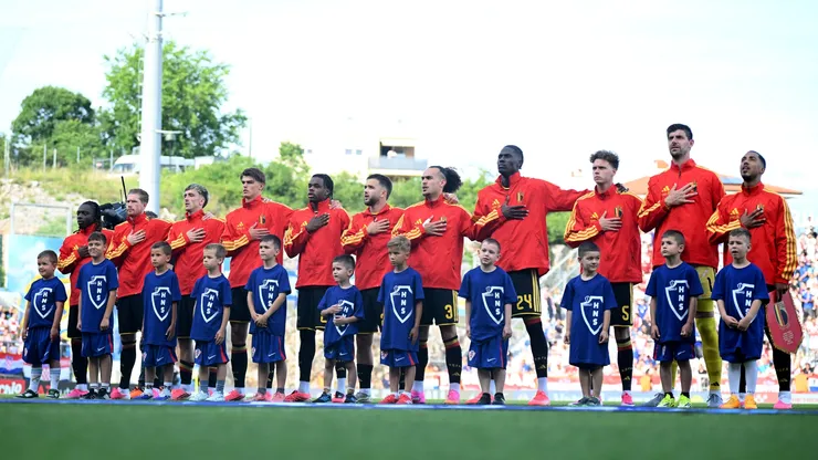 Players of Belgium stand for the national anthem prior to the international friendly match
