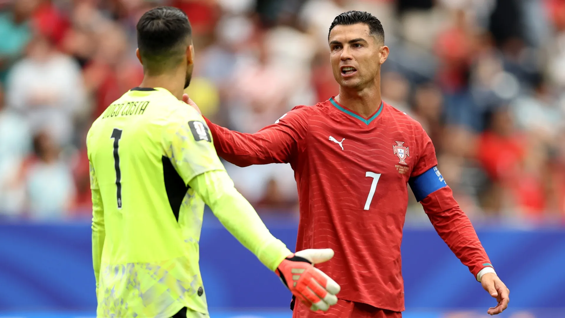 Cristiano Ronaldo #7 of Portugal reacts with Diogo Costa #1 after conceding an equalizer to Yoane Wissa #20 of Congo DR. Molly Darlington/Getty Images